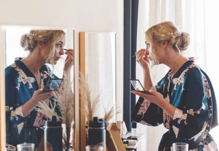 Bride doing makeup at Beach wedding in Riviera Maya.