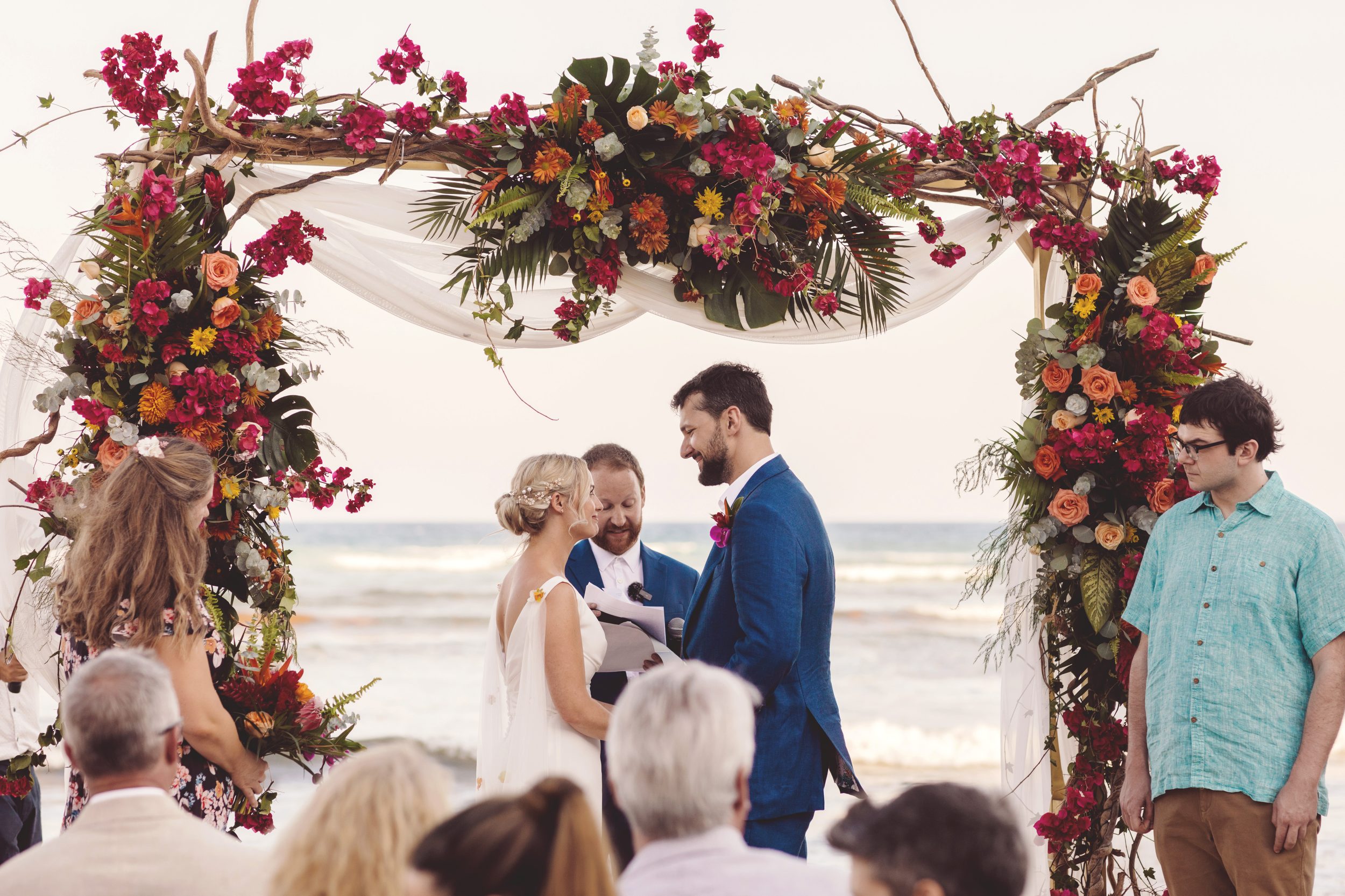 Bride and groom saying vows on beach at wedding in Riviera Maya.