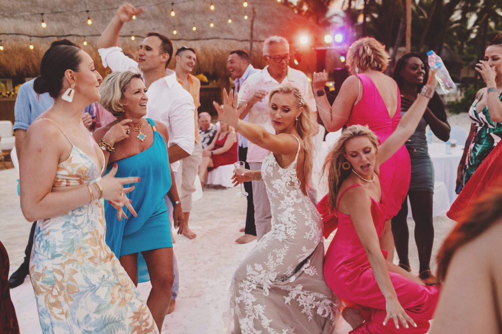 Bride dancing with guests at wedding in Cancun.
