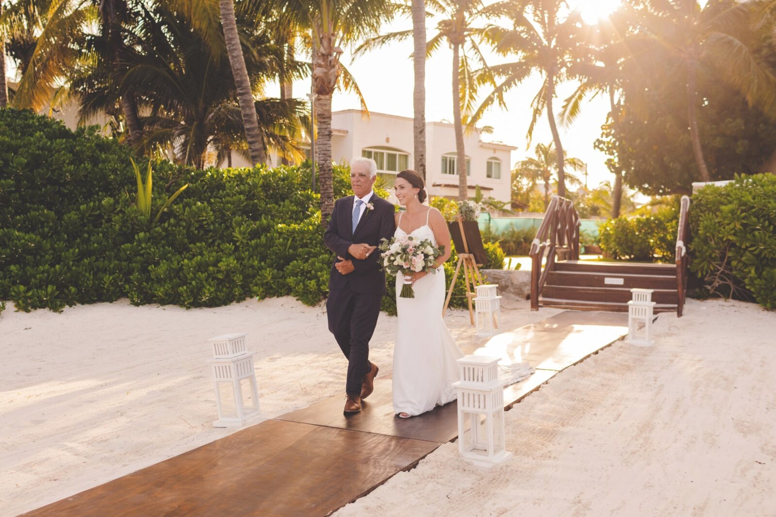 Bride walking down aisle with father at wedding in Cancun